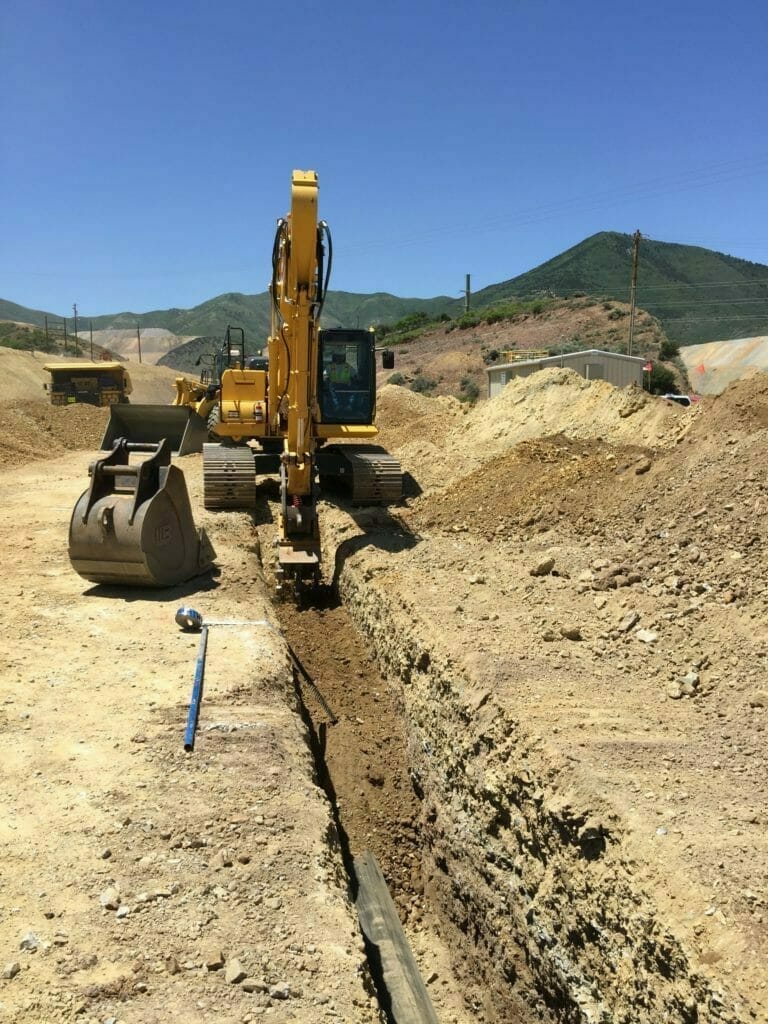 Excavator digging ditch