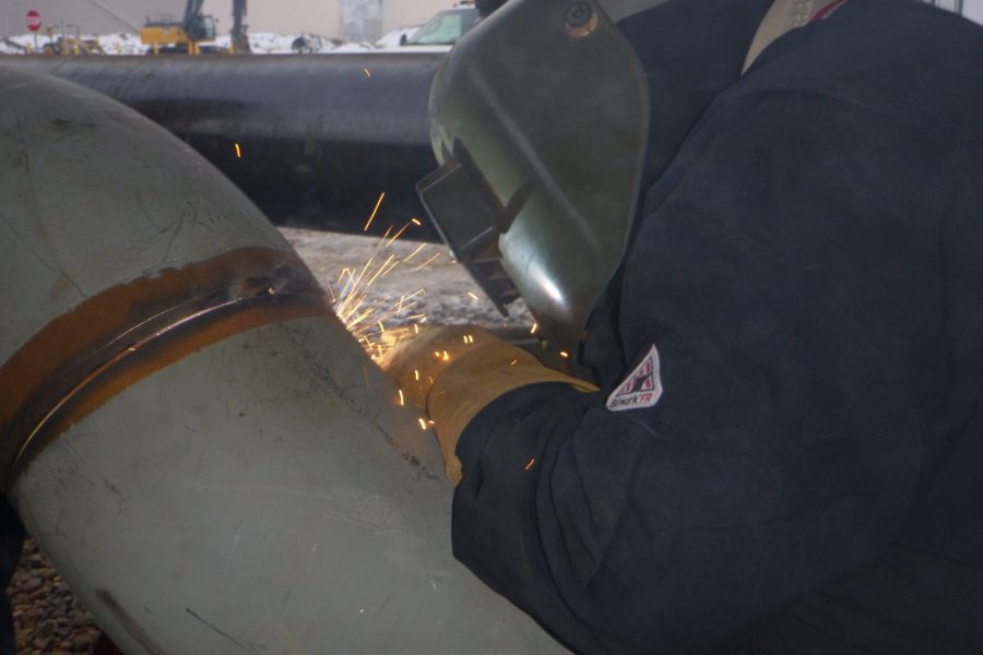 Welder Connecting Metal Pipes | Oil & Gas Refinery Construction Projects | Wollam Construction