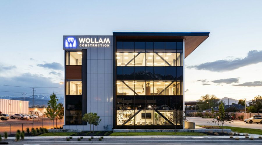 Wollam Construction headquarters office building exterior with lights
